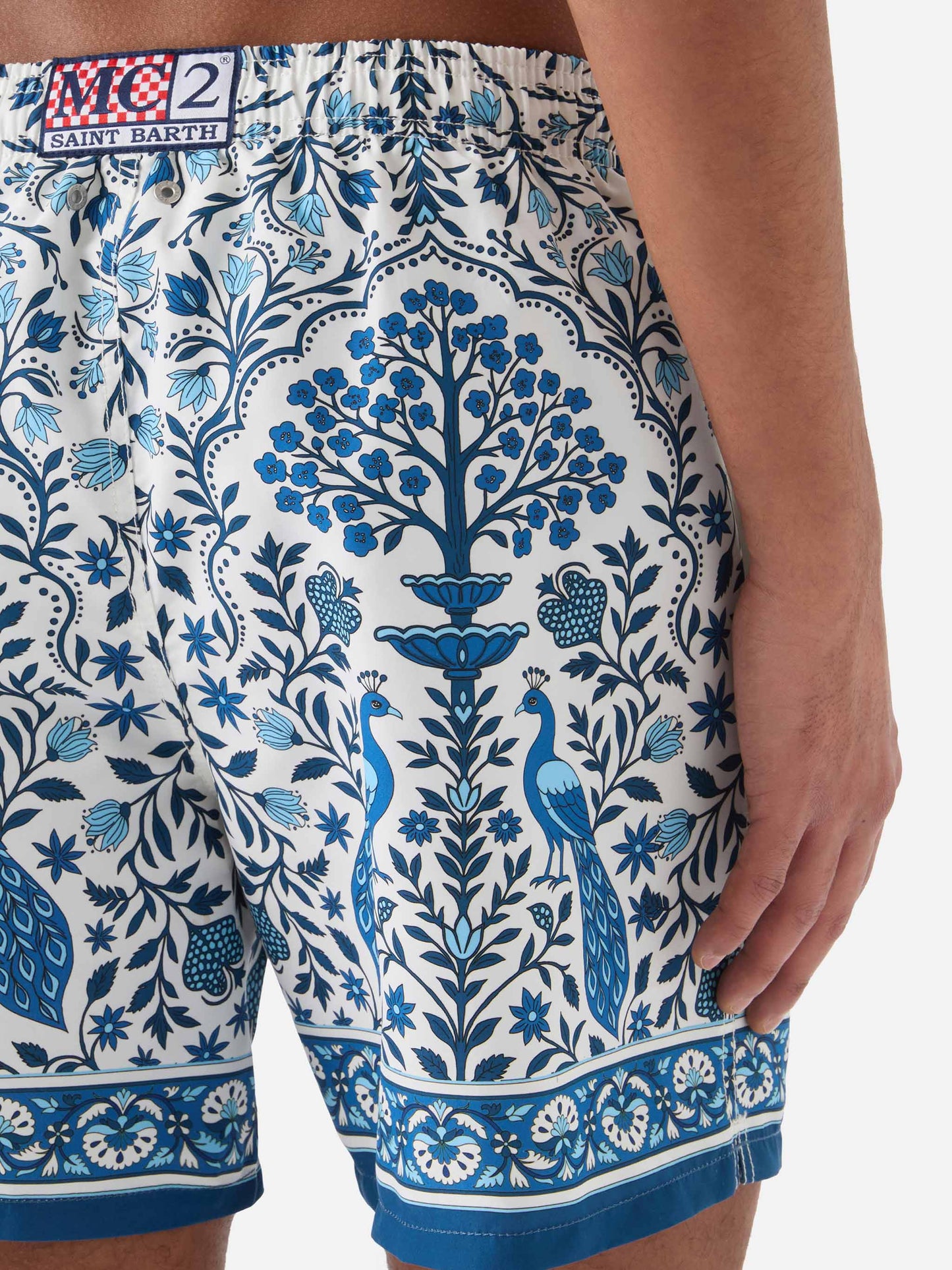 Gustavia white swim shorts with contrasting peacock print